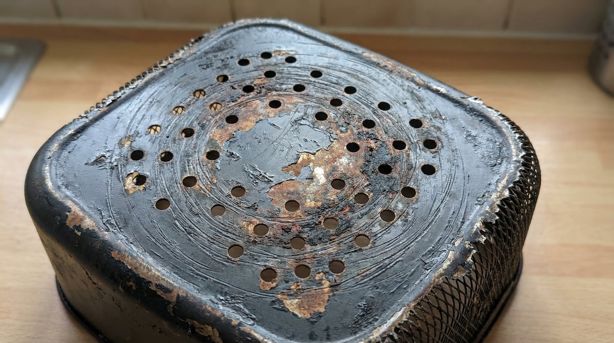 damaged air fryer basket with scratched and peeling coating