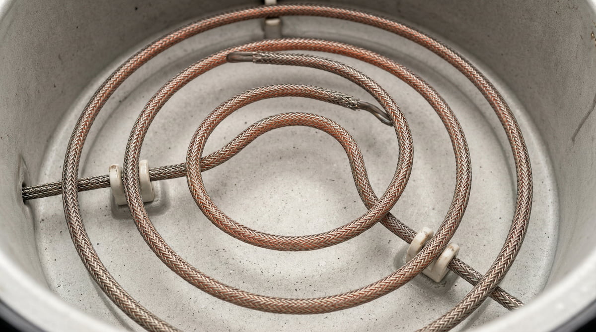 Close-up of an air fryer heating element interior — monthly cleaning prevents grease buildup and reduces fire risk