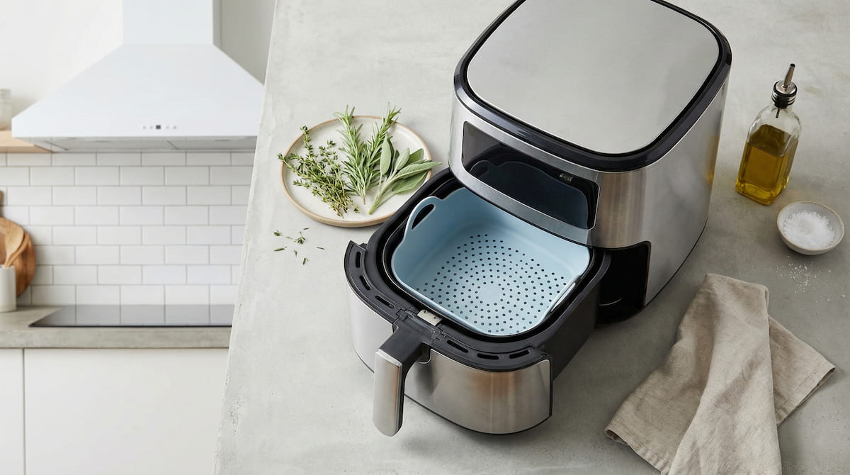Air fryer with silicone liner on a kitchen counter — proper ventilation is essential when cooking with silicone liners