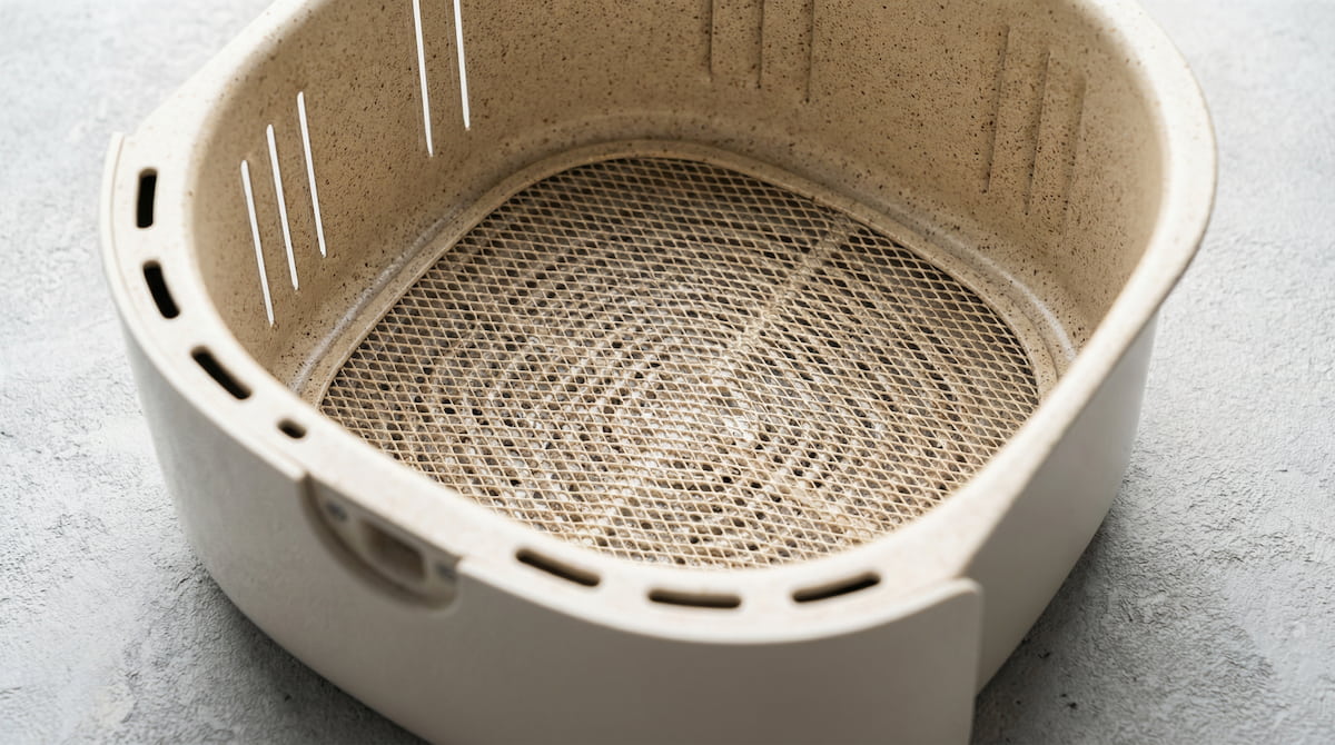 Clean ceramic-coated air fryer basket interior showing a PTFE-free nonstick surface for safer everyday cooking