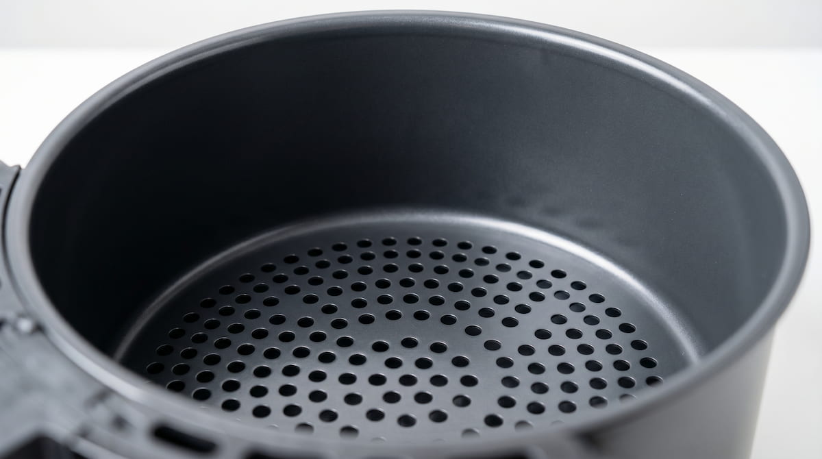 Intact ceramic air fryer basket coating — ceramic coatings last longer than PTFE with proper care
