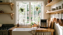 Open kitchen window with air fryer — proper ventilation reduces VOC exposure