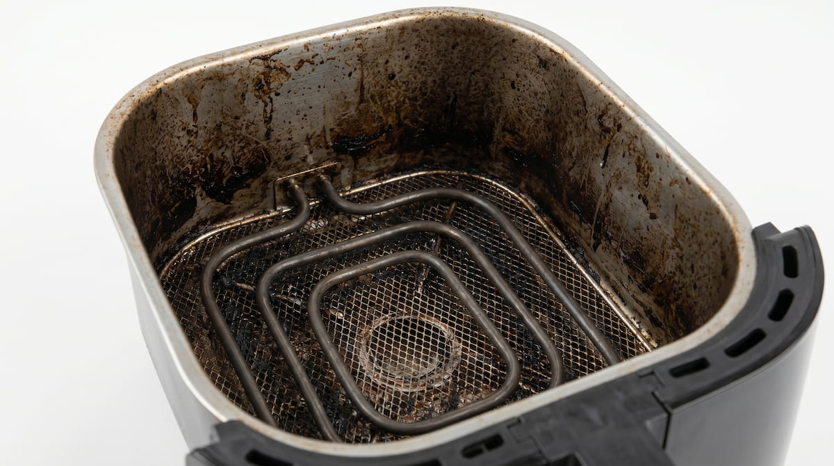 baked on grease buildup inside air fryer causing worsening smell