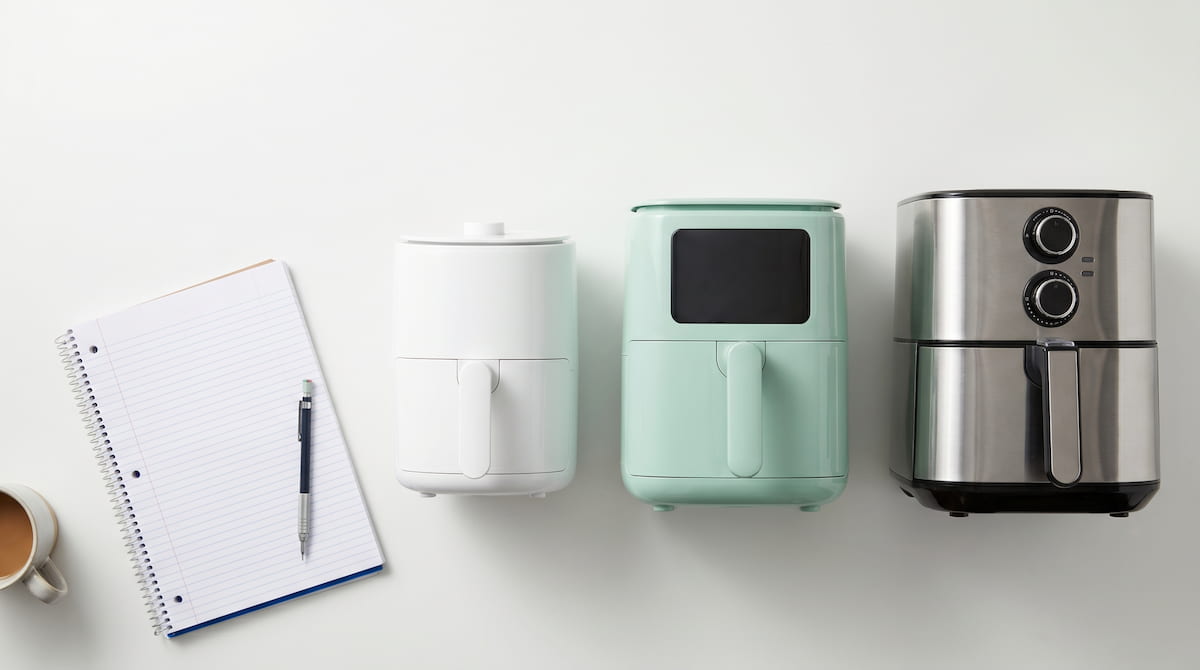 compact dorm room air fryers size comparison flat lay student notebook