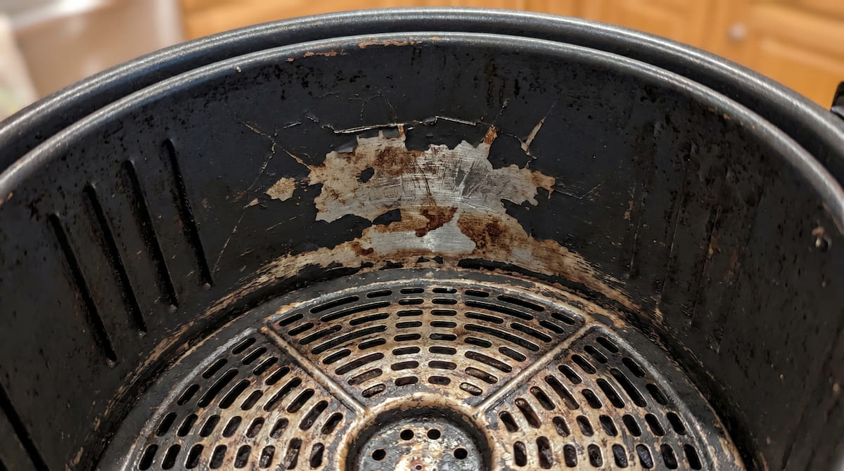 Rough and discolored PTFE coating inside a damaged air fryer basket