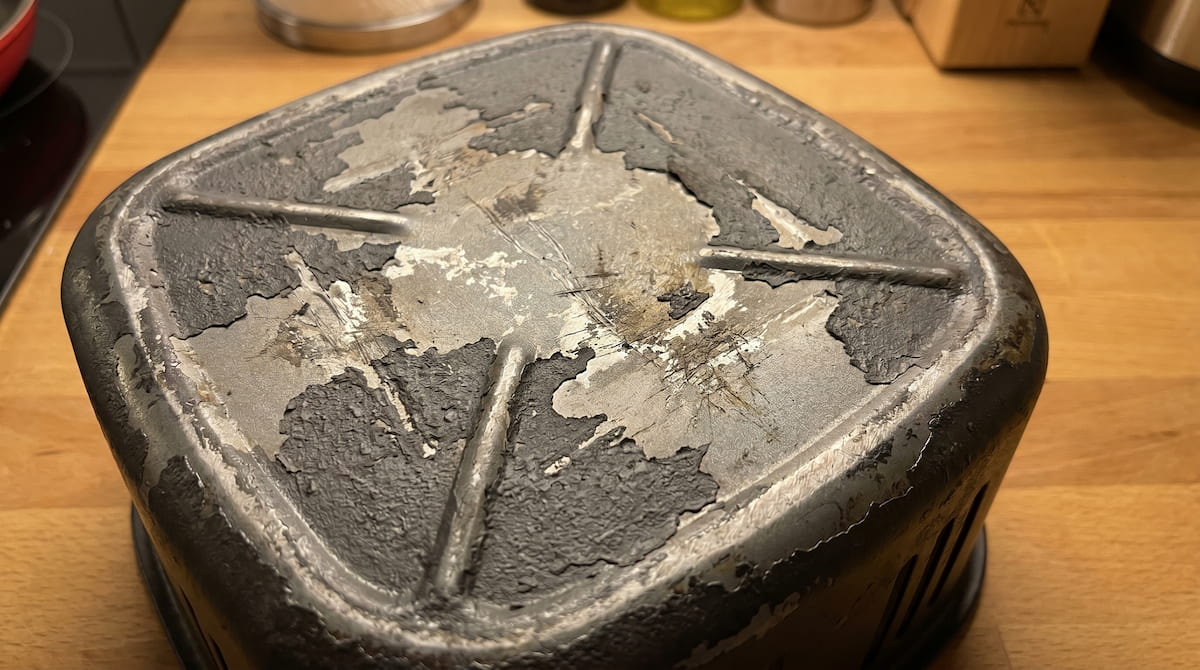 Damaged PTFE air fryer basket with rough peeling coating