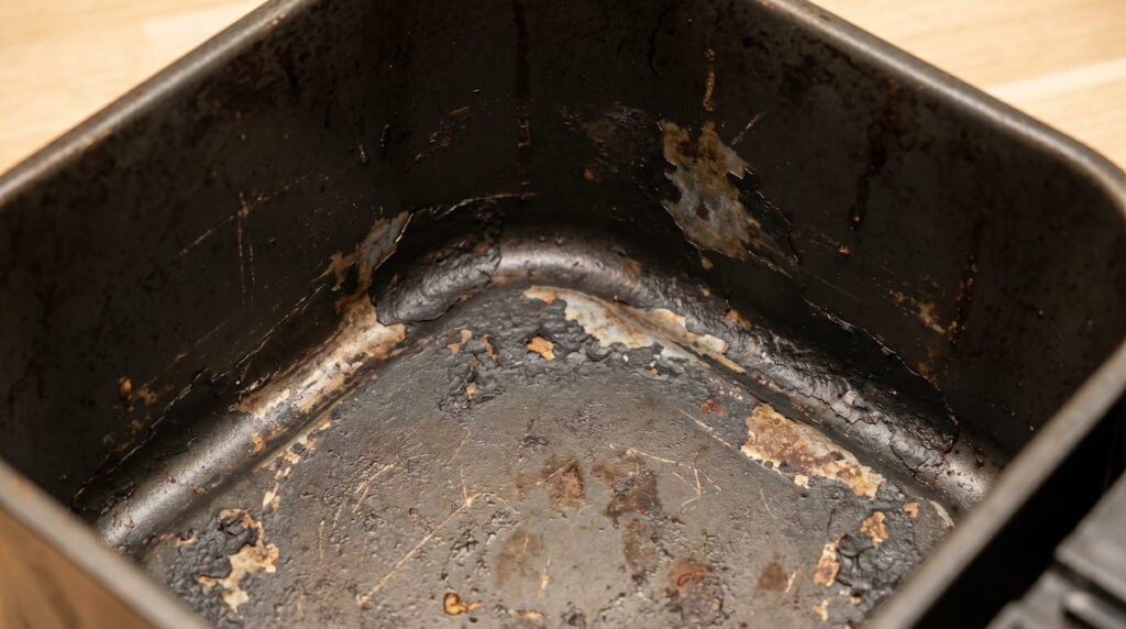 Damaged PTFE air fryer basket with peeling coating