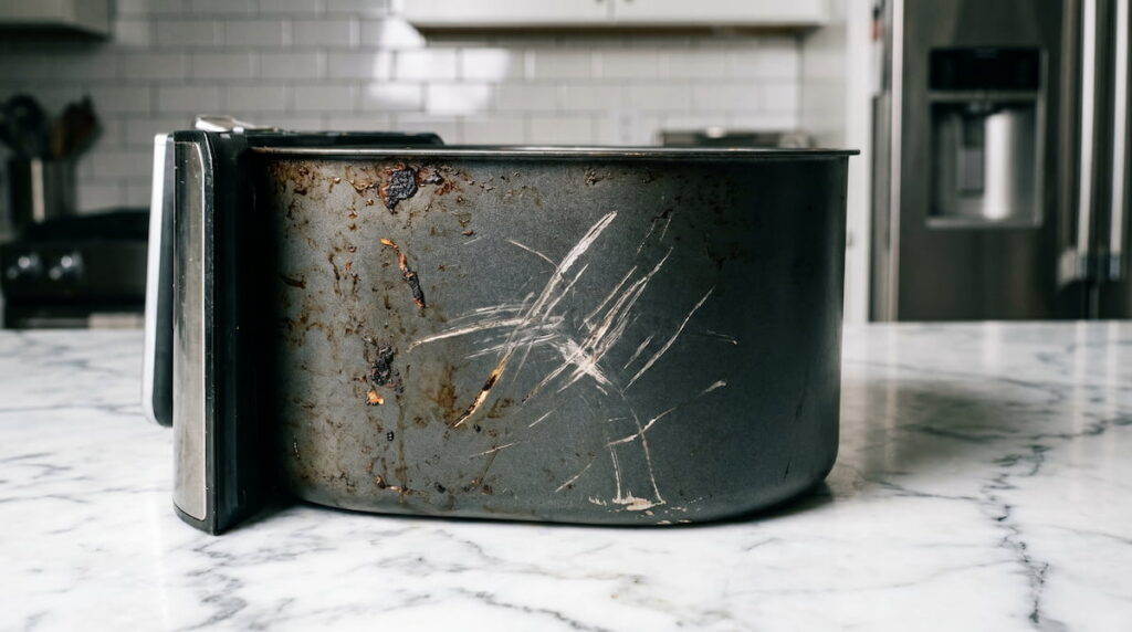air fryer basket scratched inspection close up