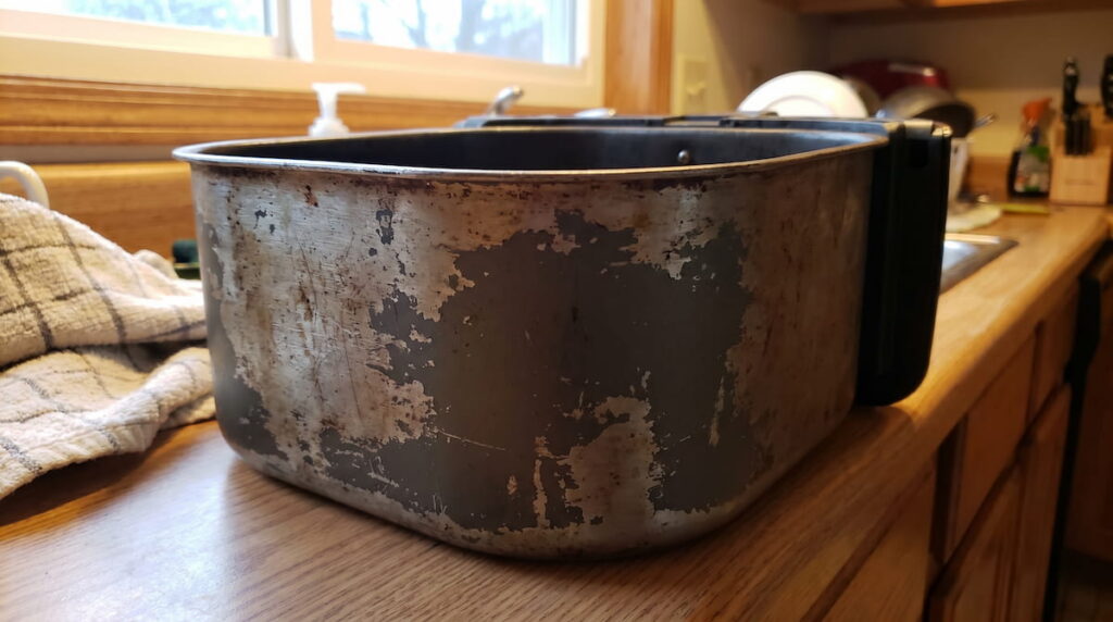 Worn air fryer basket with rough faded nonstick coating