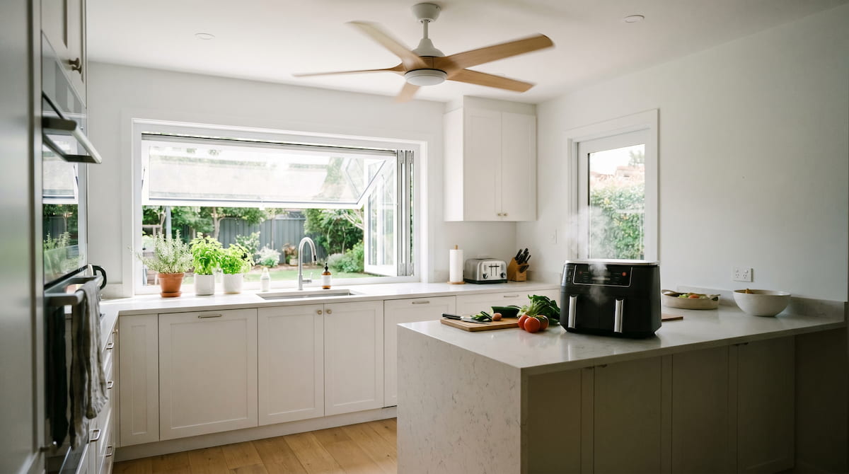 kitchen ventilation setup with open window and fan while using air fryer safely