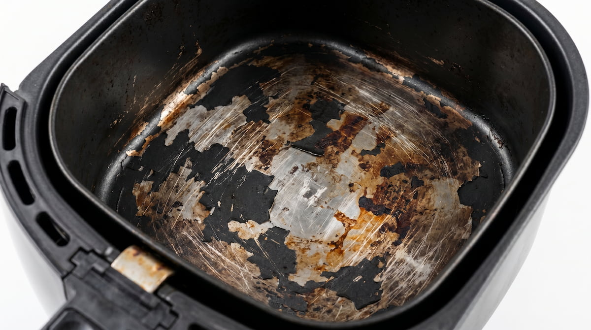 old air fryer basket with worn coating damage unsafe to use