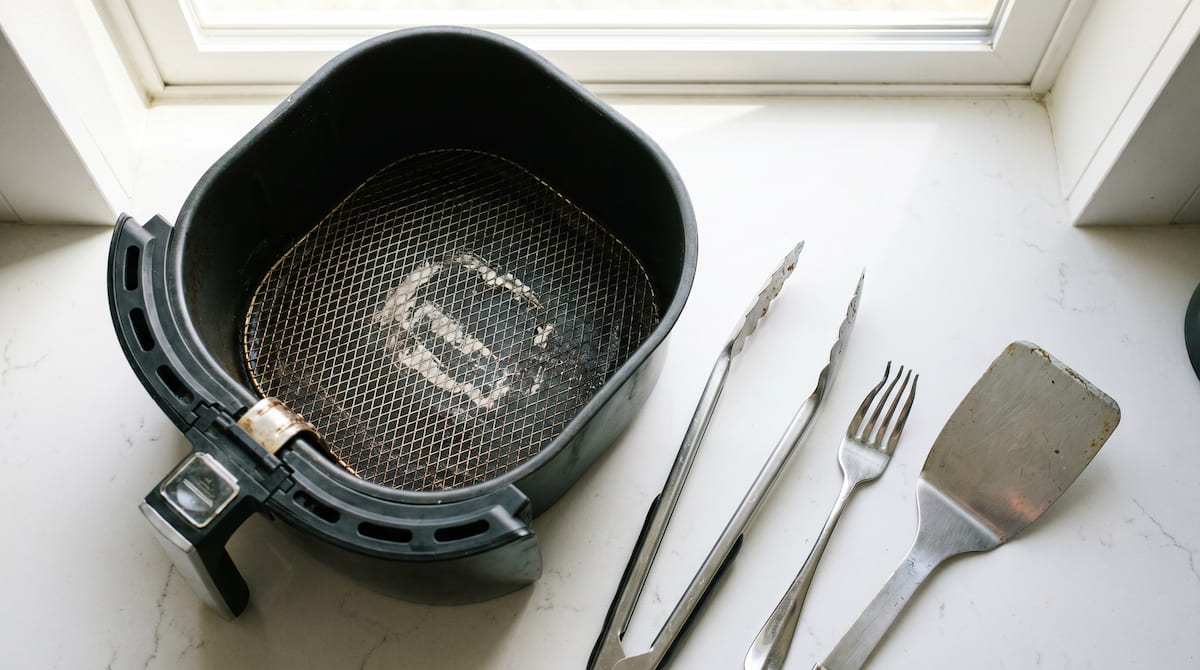 scratched air fryer basket caused by metal utensils on kitchen counter